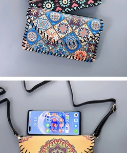 Detail showing the adjustable leather strap and handmade stitching on ethnic phone bags