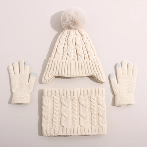 Three-piece winter cable knit set for kids featuring cream pom-pom hat scarf and gloves