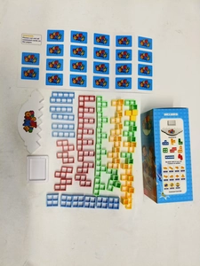 Flat lay of stacking blocks game set including pedestal and 48 colorful plastic pieces