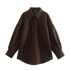 Detailed macro view of deep brown wool-style jacket with large pockets and flat lay texture