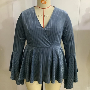 Detail of navy blue V-neck plus size top with flared sleeves and wavy textured fabric