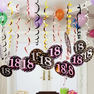 Close-up of 18th birthday hanging swirls and glittery paper cutouts for party decoration