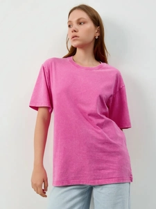Detailed texture of pink washed cotton t-shirt featuring vintage distressed finish