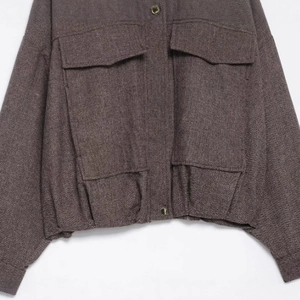 Women's dark brown herringbone bomber jacket with utility flap pockets and ribbed hem