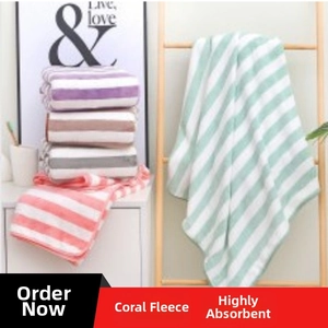 Detail of soft striped coral fleece bath towels in various colors on a wooden rack