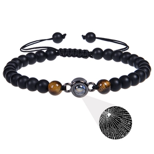 Detail of tiger eye bead bracelet with circular 100 languages I love you projection charm