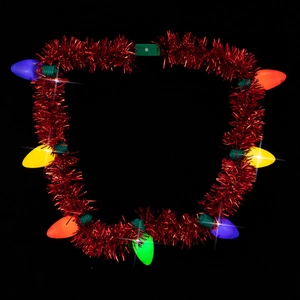 Close-up of glowing multi-color LED bulb necklace with red tinsel for Christmas party