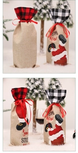 Close-up of burlap Christmas wine bottle bags with plaid trim and drawstring details