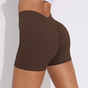 Detail of high waist scrunch butt yoga shorts in dark brown with seamless texture