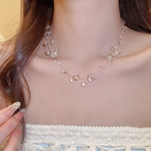 Detailed view of layered transparent crystal beaded necklace with light-refracting beads