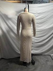 Detailed view of beige sequin dress featuring elegant geometric wave patterns on mesh fabric