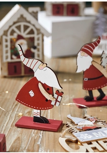Detail of wooden Santa Claus table ornaments and Merry Christmas sign for holiday decor