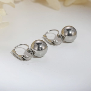 Macro shot of silver stainless steel ball leverback earrings with a mirror-polished finish