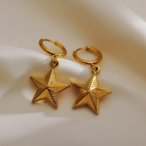 Minimalist S925 sterling silver gold plated star drop earrings for women on white fabric