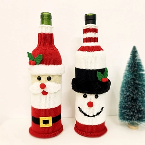 Close-up of knitted Santa and Snowman wine bottle covers for Christmas table decor
