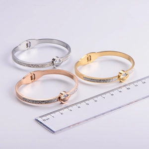 Three-color Roman numeral bangles with diamonds showing size measurement in centimeters