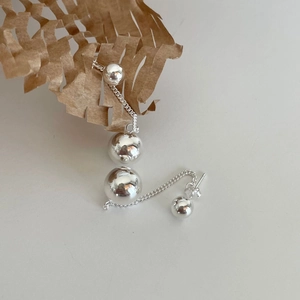 Minimalist 925 sterling silver tassel earrings with polished spheres on white background