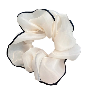 Detail of white semi-transparent chiffon hair scrunchie with elegant black stitched edges