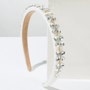 Detailed view of Baroque headband with sparkling rhinestones and white satin finish
