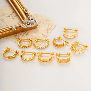 Set of 9 gold-plated surgical steel ear studs with cubic zirconia and leaf motifs