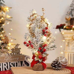 Mini tabletop Christmas tree with snow, LED lights and burlap base for festive decor