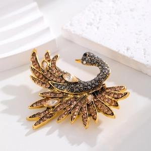 Elegant swan brooch with gold finish and sparkling black and brown rhinestones