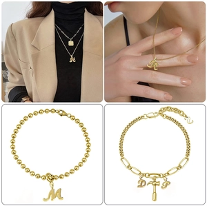 Detailed close-up of golden alphabet pendants and multi-style chain jewelry collection