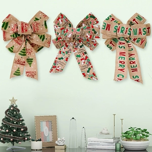 Three festive Merry Christmas bows in linen fabric hanging on a wall for holiday decor
