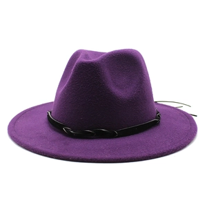 Macro detail of dark purple wool fedora hat with black braided faux leather decorative band