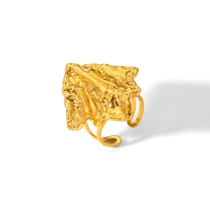 Macro detail of gold hammered texture stainless steel ring with open lava style design
