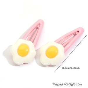 Close-up of cute poached egg hair clips with pink metal base measuring 55.5mm in length