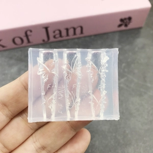 Transparent silicone nail art mold featuring three sizes of 3D butterfly designs