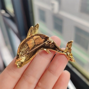 Golden dolphin brooch pin with rhinestone details shown from a back-view perspective