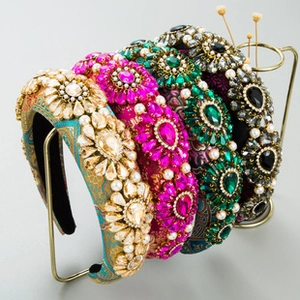 Luxury Baroque headbands with colorful rhinestones and pearls on a gold display rack