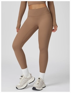 Detail view of coffee-colored high waist seamless yoga pants and cropped long sleeve top