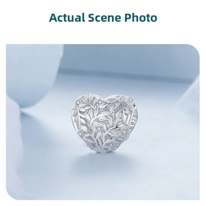 Macro shot of S925 sterling silver heart charm with leaf texture and micro-pave zircons