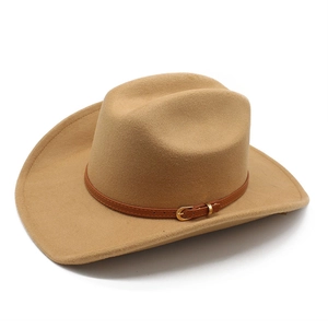 Detail of vintage western cowboy hat featuring brown leather band with gold metal buckle
