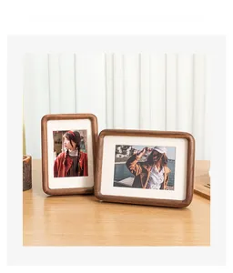 Solid walnut wood picture frames with rounded corners set against soft window light