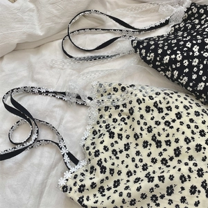 Detailed close-up of floral camisole with delicate lace trim and flower lace straps