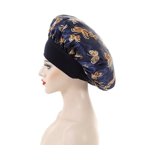 Navy blue satin bonnet with gold butterfly print and wide black elastic headband