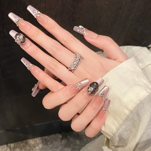 Long trapezoidal press-on nails with purple gradient, crystal accents and large gemstone