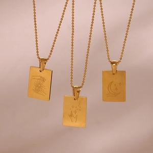 Detailed engraving of sun, moon, and star gestures on 18K gold square necklace pendants