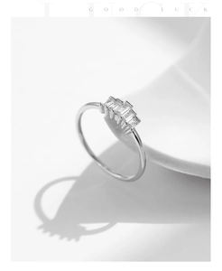 Detail of silver S925 ring featuring four rectangular sparkling cubic zirconia stones