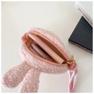 Pink plush bunny crossbody bag interior showing storage for cosmetics and accessories