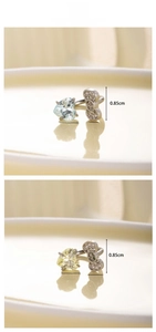 Close-up of heart gemstone and bow earrings showing precise dimensions and silver setting