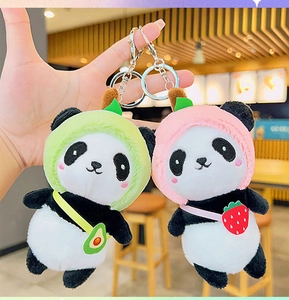 Close-up of cute panda plush keychains with avocado and strawberry fruit hoodies