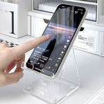 Macro shot of a minimalist clear acrylic phone holder for desk with stable structure