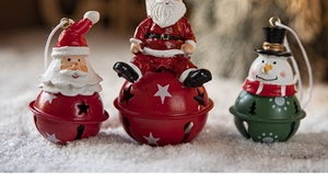 Detailed view of three festive metal Christmas bells with resin Santa and snowman figures