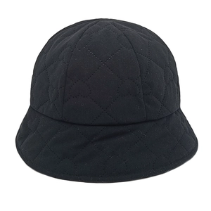 Detail showing black corduroy bucket hat with heart-shaped quilting patterns