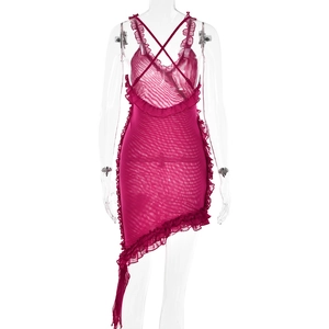 Detail of fuchsia mesh dress featuring ruffled trim, crisscross straps and open back